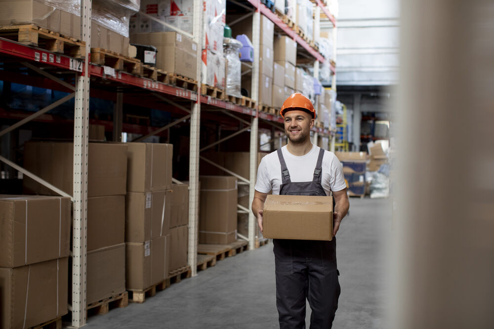 smiley-man-carrying-box-medium-shot