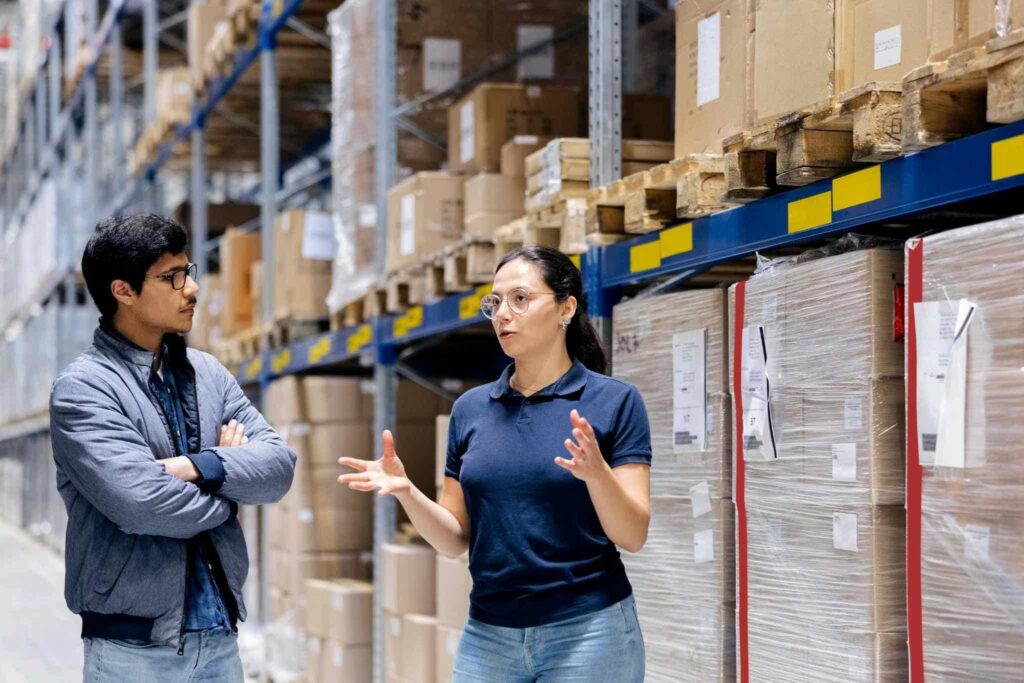 Women and men talking inside warehouse