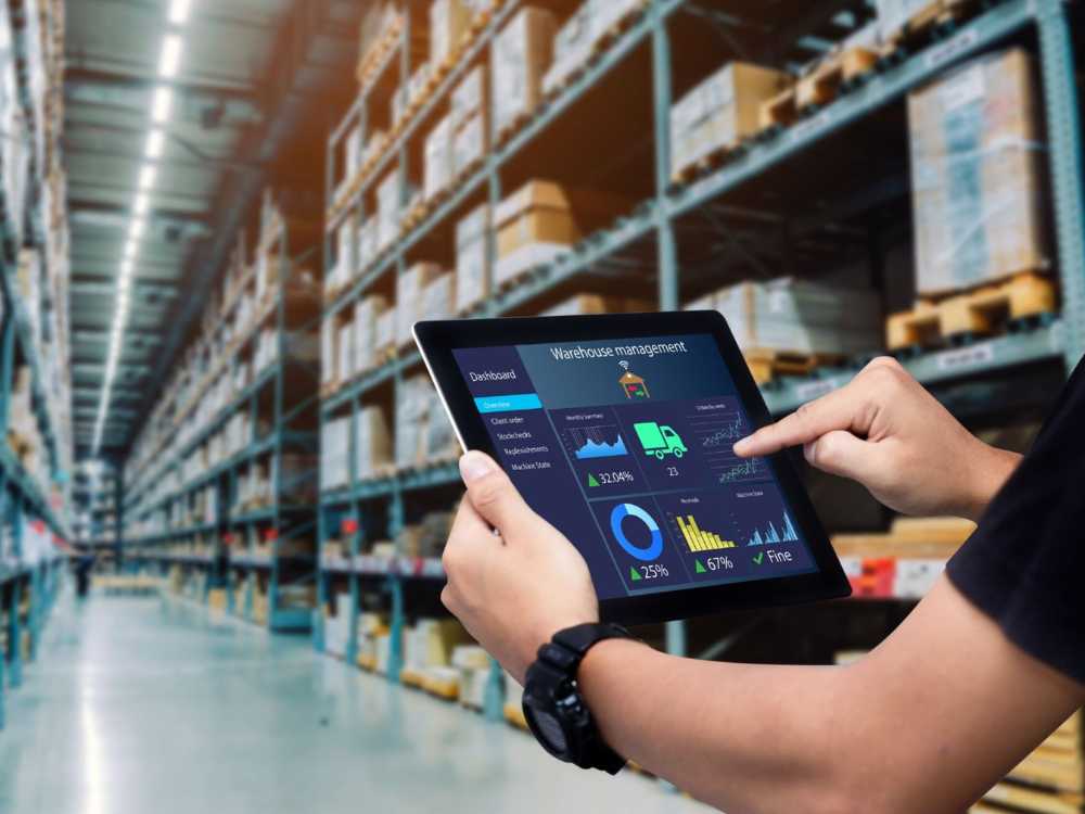 A person uses a tablet for warehouse management.