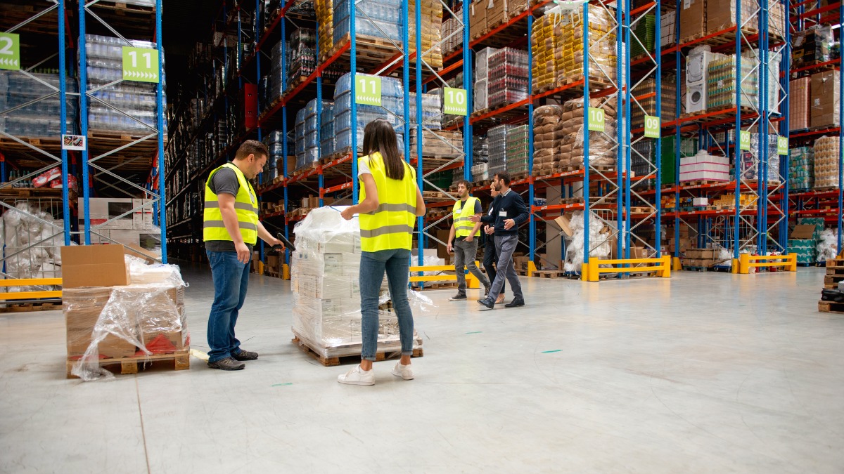 Team of warehouse workers in safety vests